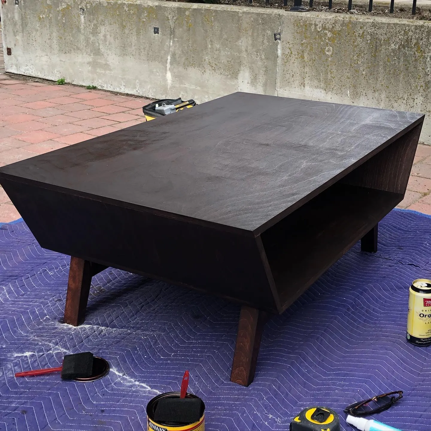 Mid-century modern coffee table being stained by Walkercraft Carpentry
