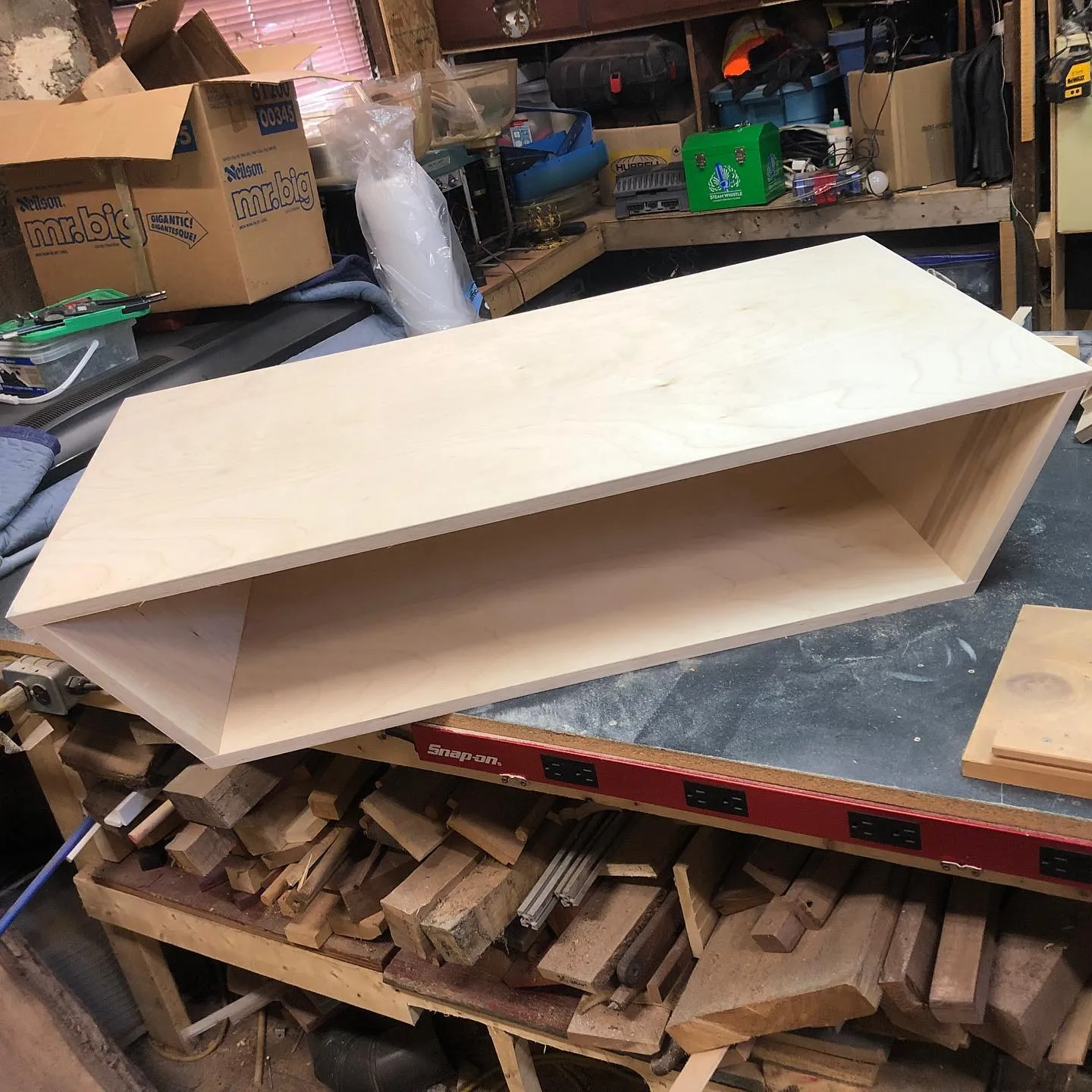 Custom birch plywood floating shelf on workbench by Walkercraft Carpentry