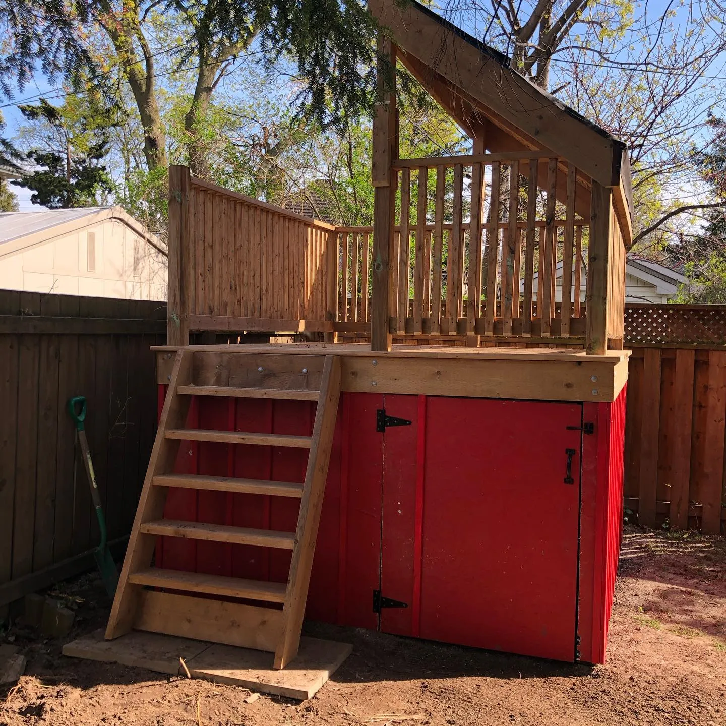Custom playhouse with stairs and storage door by Walkercraft Carpentry