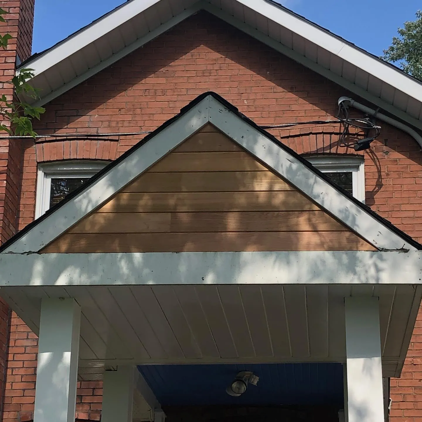 Porch gable after cedar siding restoration by Walkercraft Carpentry